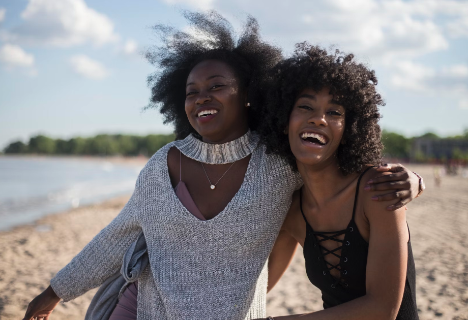 Two friends have fun on the beach.